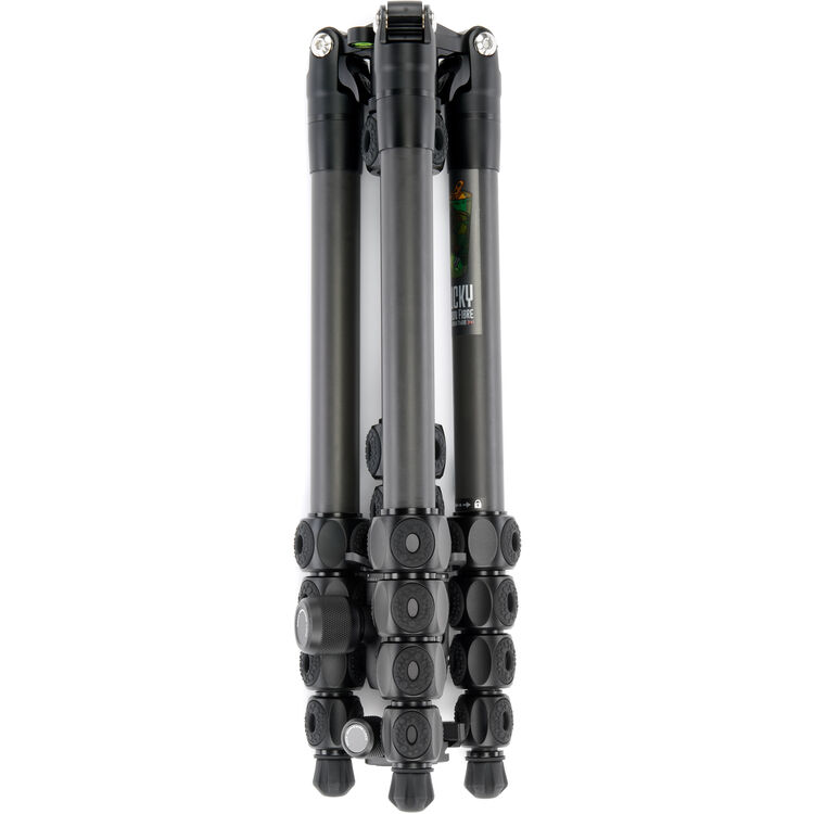 A black and dark gray folded tripod photographed on a plain white studio background.