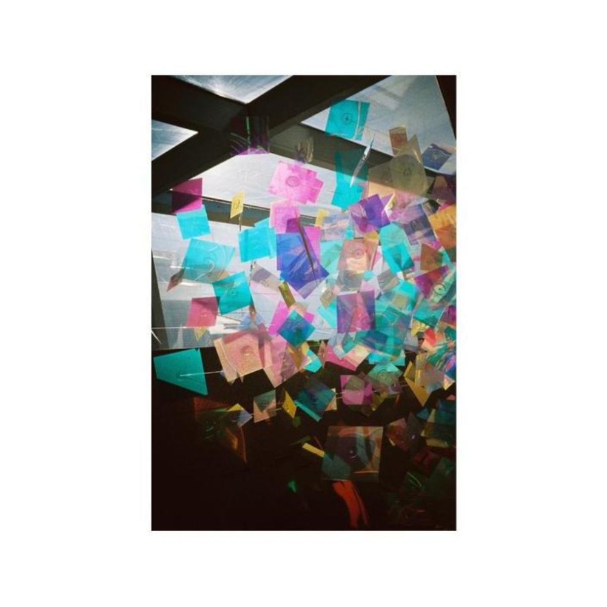 Vibrant, colorful translucent squares hanging in a bright space, captured with the distinct aesthetic of Lomography 400 film.