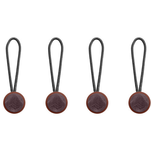 Four brown leather tags with strings on a white background