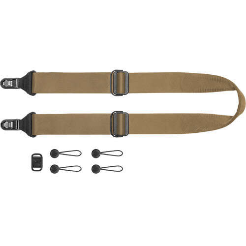 Two brown straps with black buckles and additional clips on a white background