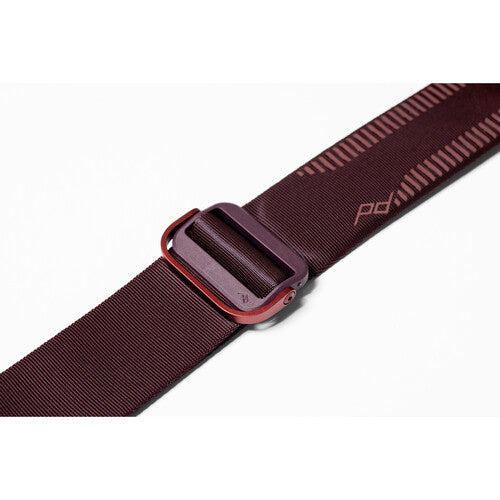 Maroon belt with a red buckle on a white background