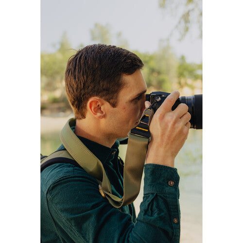 Man taking a photo with a camera in an outdoor setting