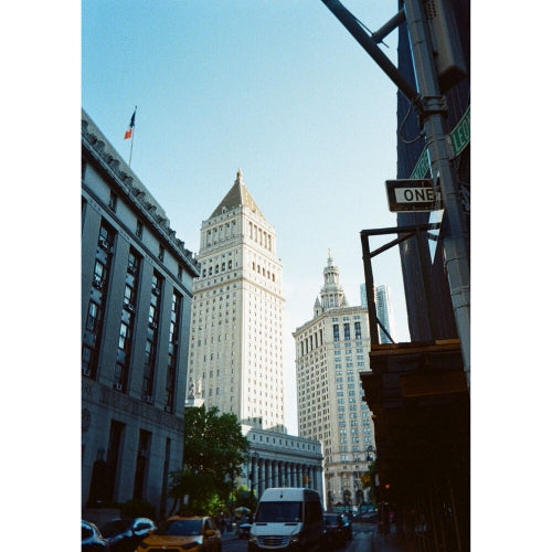 City street with tall buildings and a van in the foreground