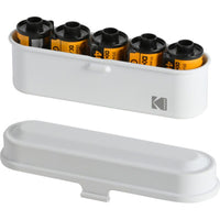 White Kodak steel 35mm film case holding five rolls of film with its matching lid placed in front.