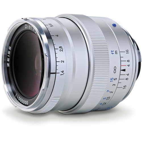 A silver Zissel Distagon 11-16mm f/4-5.6 Distallens camera lens with white, black, and blue markings on its focusing rings, shown on a clean white background.