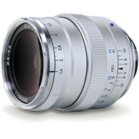 A silver Zissel Distagon 11-16mm f/4-5.6 Distallens camera lens with white, black, and blue markings on its focusing rings, shown on a clean white background.