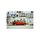 Red and white taxi parked on a city street, captured with the cool blue tones and sharp grain of Amber 400 35mm film.