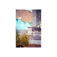 An abstract architectural photograph featuring a textured stucco wall with a painted turquoise wave design, a gray column, steps, and foreground grasses under warm sunlight. Signed by Eric Joseph in the bottom right corner.
