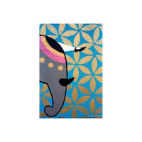 A close-up of a colorful elephant illustration on a blue background with a repeating gold floral pattern. The elephant is gray with pink, black, and white details, and the background has a metallic gold leaf texture.