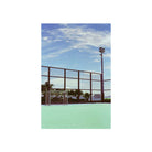 Outdoor soccer goal on a green court under a blue sky, captured with cinematic Amber T200 35mm color film.