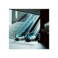 Cinematic shot of a modern escalator and stairs captured on Amber AHU T640 35mm color film with cool, tungsten-balanced tones.