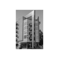 Black and white architectural photograph of a modern apartment building with balconies, shot on Arista EDU 100 film.