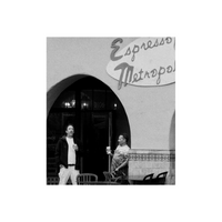 Black and white image of Espresso shop with two men holding paper coffee cups.