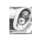 Black and white image of a car angled headlight.