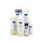Arista Rapid E-6 slide film developing kit with six labeled plastic bottles of chemical solutions on a white background.