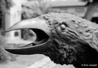 Close-up of a bird-like creature with an open mouth sculpture