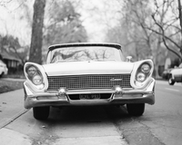 Black and white image of an older car with angled headlights