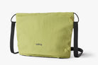 Green bag with black straps on a white background