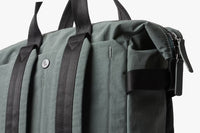 Green Bellroy Totepack bag with black straps on a white background