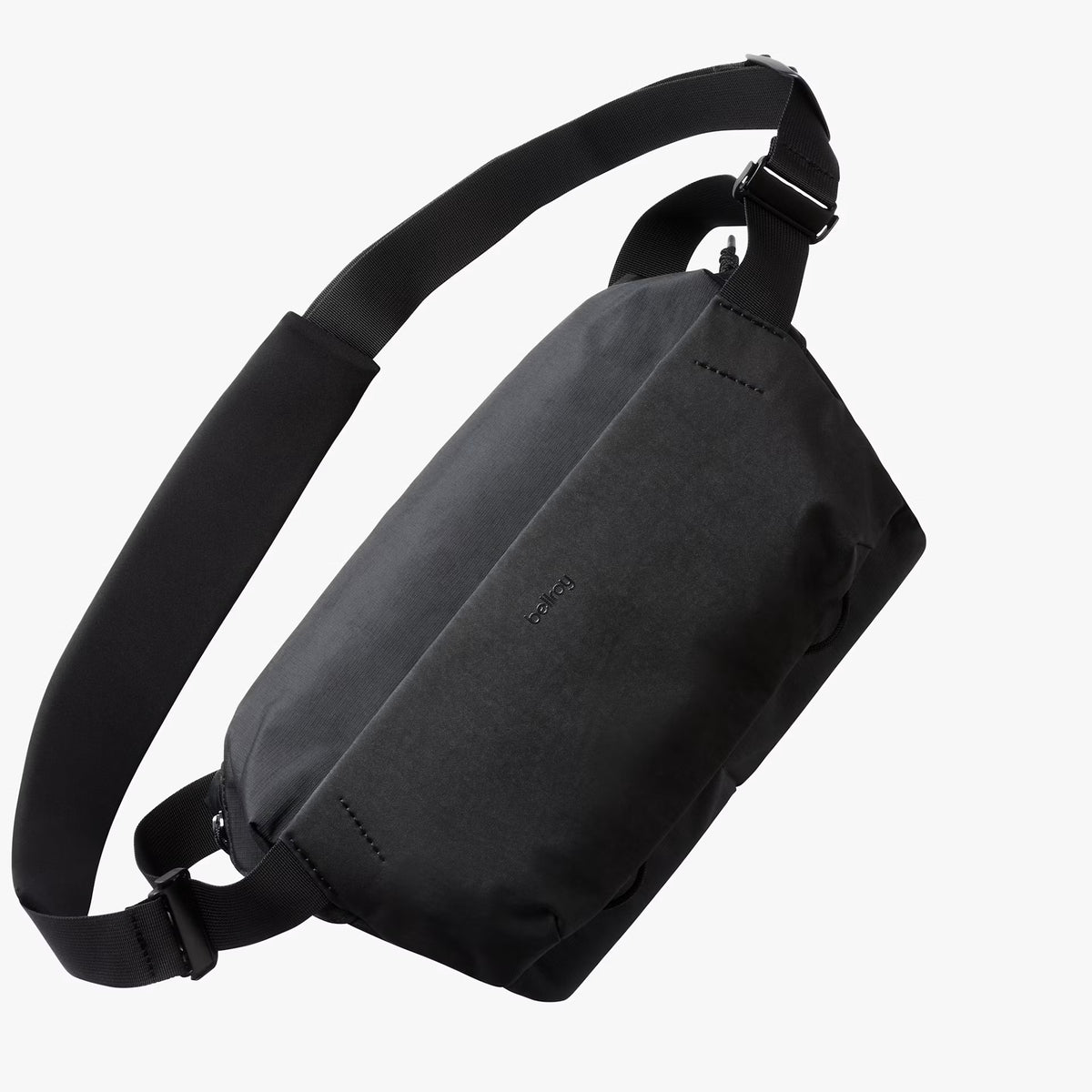 A black nylon sling bag with an adjustable shoulder strap, shown from a three-quarters perspective against a light gray background.