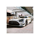 White Mercedes-AMG GT3 race car parked in a pit lane, captured with the vivid colors and fine grain of Candido 200 film.