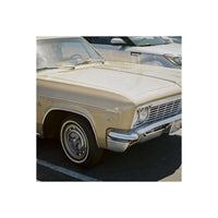 Vintage gold sedan parked outdoors, captured with the vivid colors and sharp detail of Candido 400 35mm film.