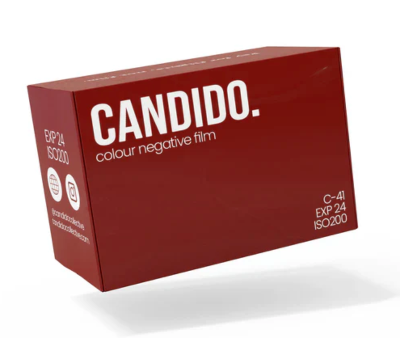 A red box of Candid. colour negative film, shown at an angle on a white background with a soft shadow underneath.