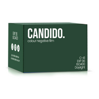 A dark green box of Candid. colour negative film, shown at a three-quarter angle on a white background with a soft reflection.