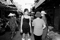 Black and White photo of woman in a black dress in an asian market