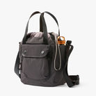 Gray backpack with a water bottle on a white background