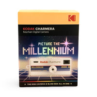 Kodak Charmera Keychain Digital Camera blind box packaging, featuring a retro 1980s pixel-art style design with a yellow top section, black middle band, and a blue starry background with a white camera illustration.