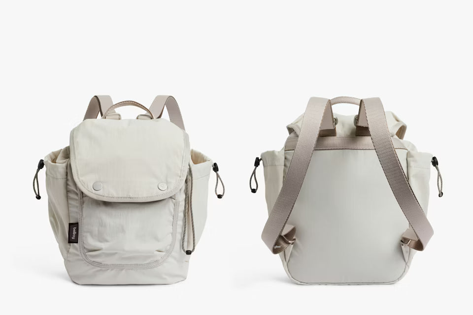 Two beige backpacks on a white background