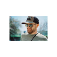 Man with a beard wearing a baseball cap and sunglasses, captured on CineStill 400Dynamic 35mm film with warm, natural tones.