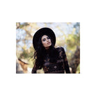 Woman in a black hat and patterned top shot on CineStill 50Daylight 120 film with soft, natural bokeh background.