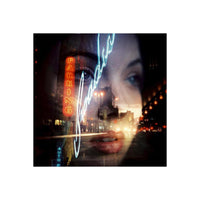 Double exposure of a woman's face and a neon-lit city street captured on CineStill 800T tungsten film.