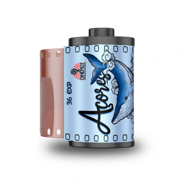 A roll of Acorex 36 EXP film with a light blue label featuring a blue and white dolphin illustration and black script text, shown alongside its brown film base on a white background.
