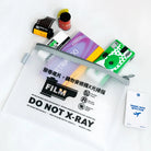 Film packaging with 'Do Not X-Ray' label and other items on a white background