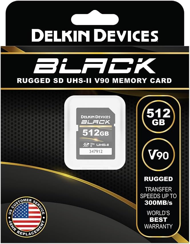 Delkin Devices Black 512GB UHS-II SD memory card in its retail packaging, featuring a black and gold design with product specifications and a customer replacement guarantee badge.