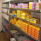 Storage shelves with various boxes and analog camera film in a warehouse setting