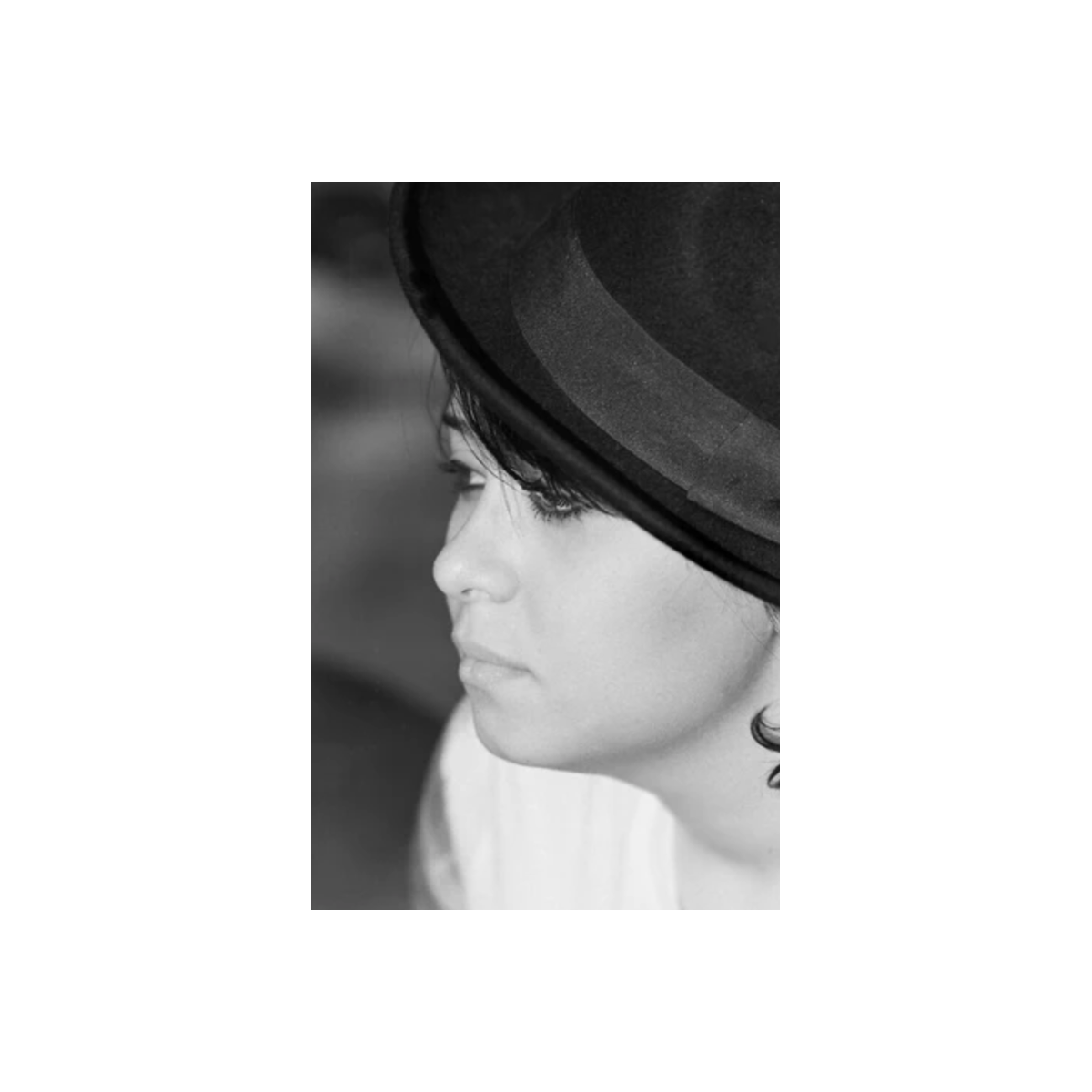 Sharp black and white portrait of a person wearing a fedora, captured on FPP Dracula 64 ISO 35mm film.