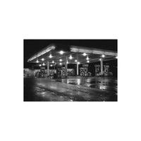 Black and white night shot of a gas station under bright overhead lights, captured on FPP Love 200 35mm film.