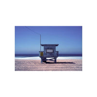 Lifeguard tower on a sandy beach under a deep blue sky, captured with FPP Low ASA 1.6 color film for a cinematic look.