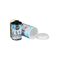 FPP Yeti 6 ISO 35mm black and white film cartridge with a yeti-themed label next to its open plastic storage canister.