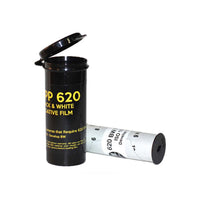 Two rolls of 620 Black & White negative film, with one standing upright showing its black plastic case lid open and the other lying down showing the white film roll with black text.