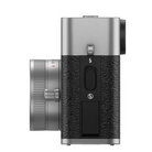 Camera with textured black body and metallic silver accents on a white background