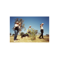 Three people walking through a dry, grassy field under a bright blue sky, captured on FilmNeverDie SORA 200 color film.