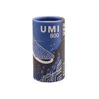 FilmNeverDie UMI 800 ISO 35mm film in a blue cylindrical cardboard canister featuring a whale shark illustration.