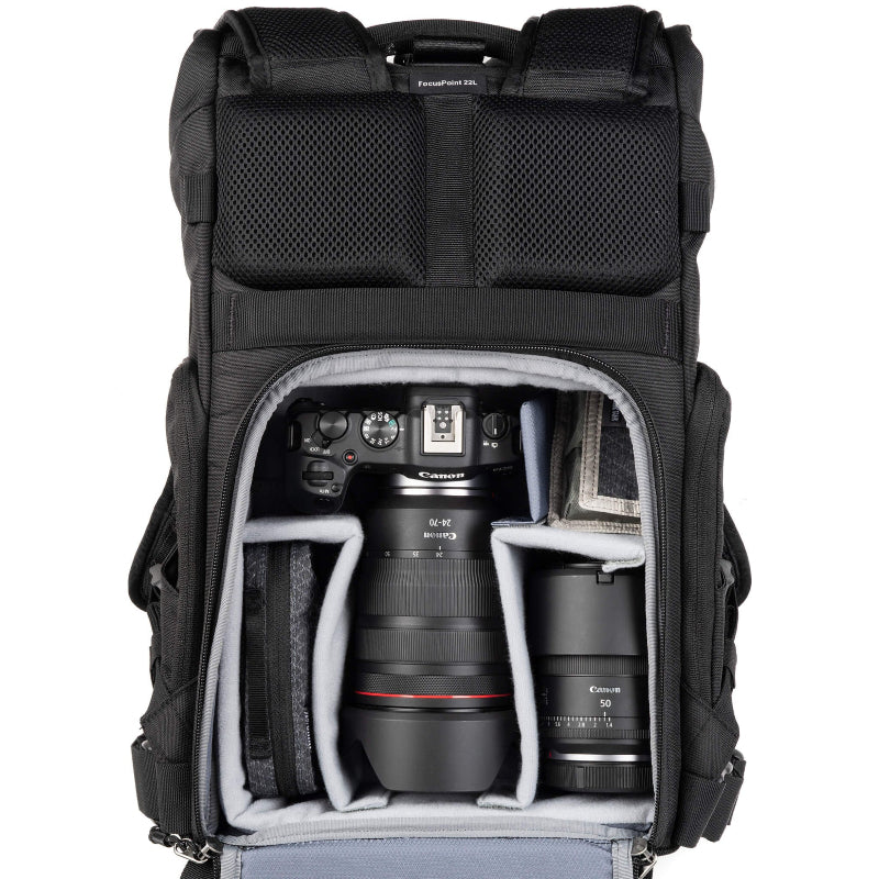 Black camera backpack with Canon camera and lenses inside on a white background