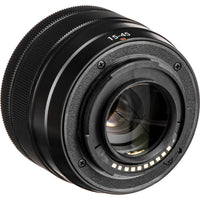 A close-up studio shot of a black camera lens with '15-45' printed in white on the front, set against a plain white background.