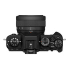Top view of a black camera body with lens on a white background